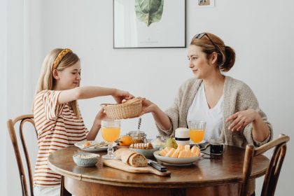 A warm family breakfast with mother and daughter sharing a meal in a cozy dining area.